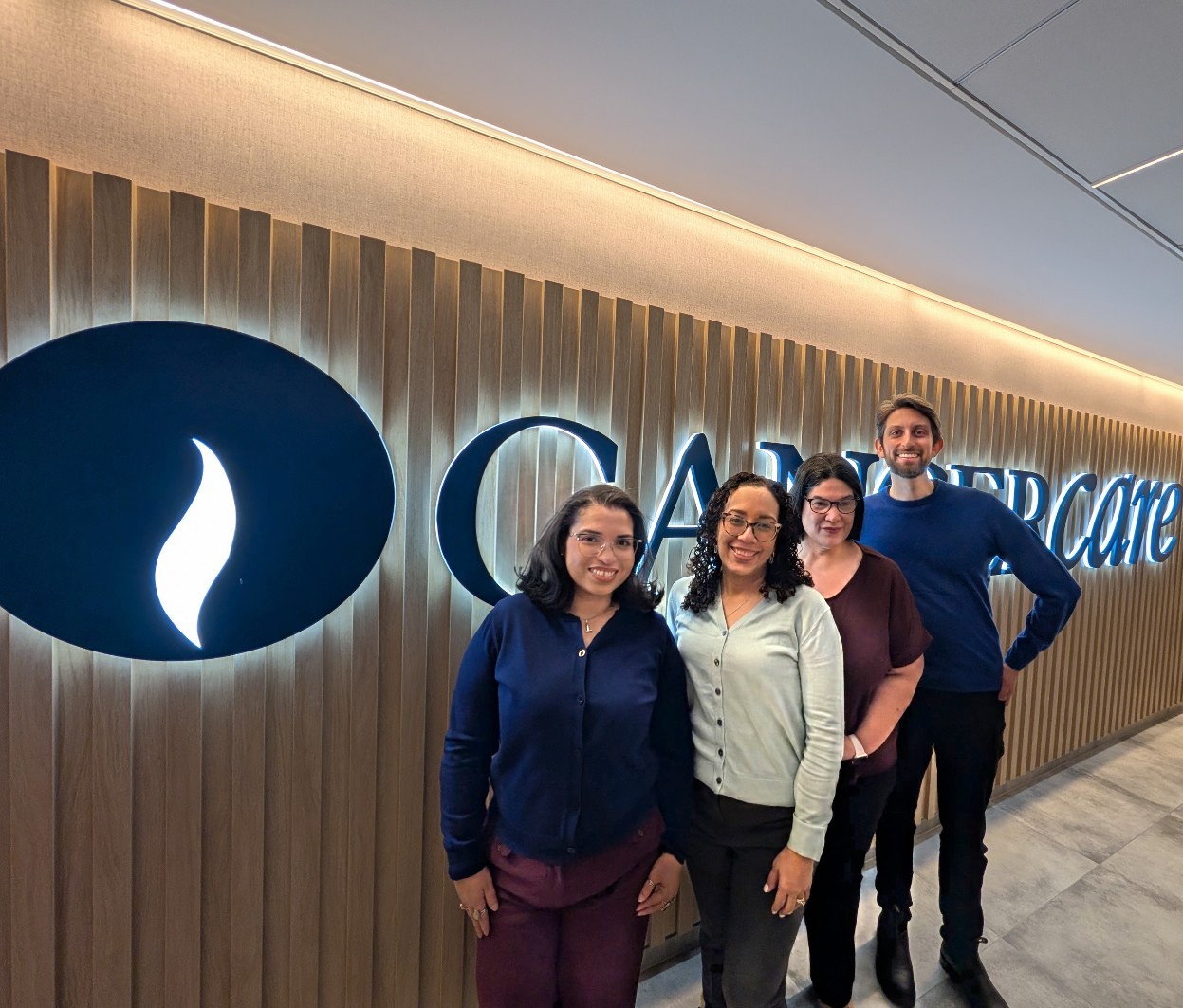 Group of social workers standing in front of CancerCare sign