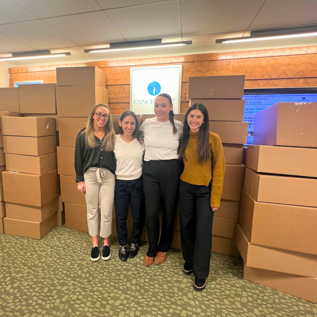 Social workers in front of Winter Warmth packages