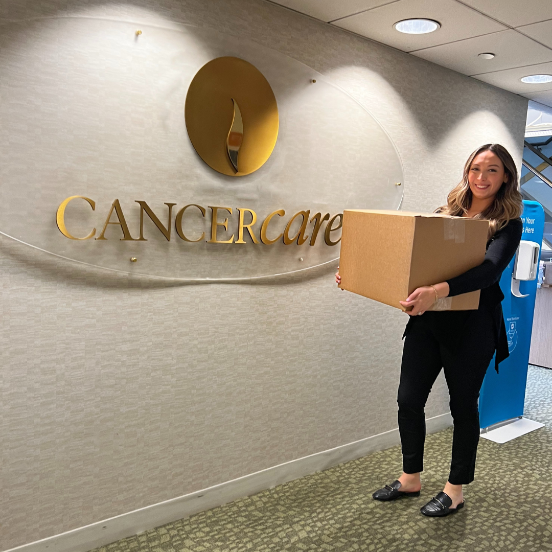 Winter Warmth Program package in front of CancerCare sign