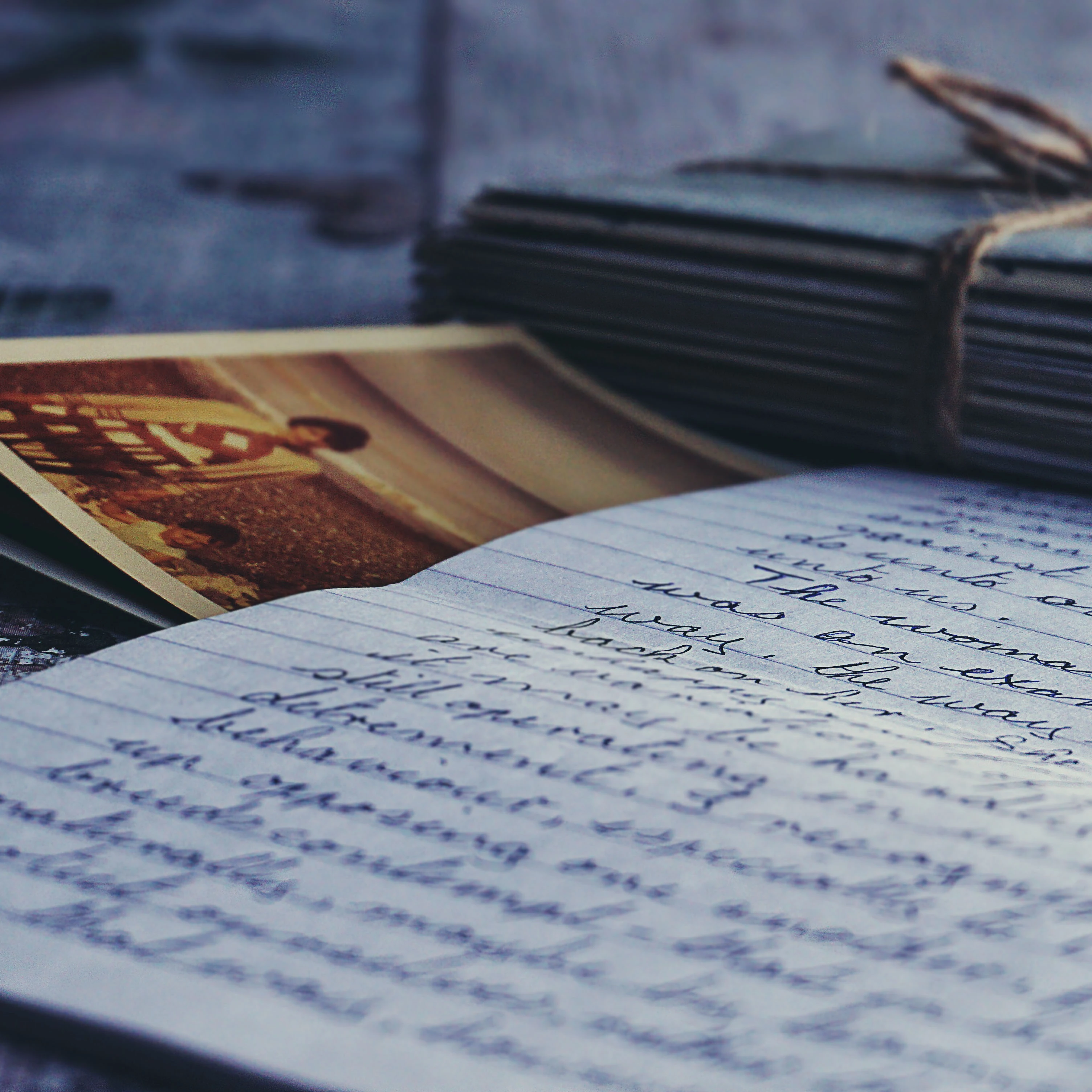 Photo of a handwritten letter with a photo and bundle of envelopes